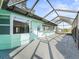 Enclosed porch featuring a metal cage roof, providing ample lighting with exterior views at 11584 Se 175Th St, Summerfield, FL 34491