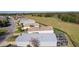 Aerial view of houses and a large open field at 1639 Campos Dr, The Villages, FL 32162