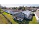 Aerial view of house with screened-in patio and surrounding homes at 1639 Campos Dr, The Villages, FL 32162