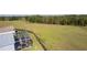 Expansive backyard featuring a screened patio and a large, fenced grassy area at 1639 Campos Dr, The Villages, FL 32162