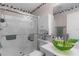 Bathroom featuring a glass-enclosed shower, decorative wall art, and a green glass vessel sink at 1639 Campos Dr, The Villages, FL 32162