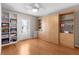 Versatile bedroom with built-in shelving and wood floors, providing functional storage solutions and style at 1639 Campos Dr, The Villages, FL 32162