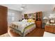 Comfortable bedroom with a ceiling fan, wooden furniture, and a decorative quilt on the bed at 1639 Campos Dr, The Villages, FL 32162