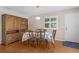 Dining room with hardwood floors, hutch, white door, and bright window at 1639 Campos Dr, The Villages, FL 32162