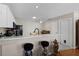 Bright kitchen featuring white cabinets, black appliances, and marble countertops overlooking an eat-in dining space at 1639 Campos Dr, The Villages, FL 32162