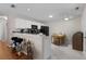 Eat-in kitchen with white cabinets, breakfast bar, and tile floors at 1639 Campos Dr, The Villages, FL 32162
