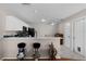 Bright kitchen featuring white cabinets, black appliances, and marble countertops overlooking an eat-in dining space at 1639 Campos Dr, The Villages, FL 32162