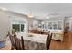 Bright living room opens to the dining area and features a built-in bookcase and ceiling fan at 1639 Campos Dr, The Villages, FL 32162