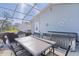 Enjoy outdoor dining on the screened patio with a table, chairs, and relaxing hot tub at 1639 Campos Dr, The Villages, FL 32162