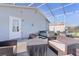 Covered patio with a hot tub and outdoor seating, perfect for entertaining guests at 1639 Campos Dr, The Villages, FL 32162