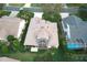An aerial view of the property showing the home, pool, and lanai at 1897 Caryle Ln, The Villages, FL 32162