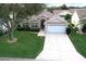 Single story home with a driveway and large yard at 1897 Caryle Ln, The Villages, FL 32162