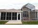 Backyard featuring an enclosed patio and a covered hot tub area at 1897 Caryle Ln, The Villages, FL 32162