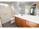 Bright bathroom featuring a white vanity, tile flooring and a shower-tub combo at 1897 Caryle Ln, The Villages, FL 32162