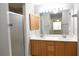 Bathroom featuring double sinks, vanity and shower with sliding doors at 1897 Caryle Ln, The Villages, FL 32162