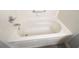Close up on a white bathtub with jets and chrome fixtures at 1897 Caryle Ln, The Villages, FL 32162