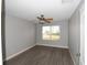 Bedroom with wood laminate floors, ceiling fan, and window overlooking the outdoors at 1897 Caryle Ln, The Villages, FL 32162