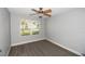 Bedroom with wood laminate floors and a large window for optimal sunlight at 1897 Caryle Ln, The Villages, FL 32162