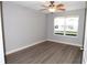 This is a bedroom featuring a window and ceiling fan at 1897 Caryle Ln, The Villages, FL 32162