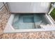Hot tub on the property with tile surround and privacy walls at 1897 Caryle Ln, The Villages, FL 32162