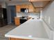 Well-equipped kitchen featuring quartz countertops, stainless steel appliances, and efficient wooden cabinets at 1897 Caryle Ln, The Villages, FL 32162