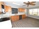 Well-lit kitchen featuring wood cabinetry, stainless steel appliances, and breakfast nook area at 1897 Caryle Ln, The Villages, FL 32162