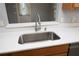 Bright kitchen featuring stainless steel sink, quartz countertops, and an opening to the dining room at 1897 Caryle Ln, The Villages, FL 32162