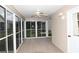 Enclosed lanai with a ceiling fan, tile floors, and views of the backyard at 1897 Caryle Ln, The Villages, FL 32162