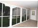 Screened in lanai with tile flooring and views of the backyard landscaping at 1897 Caryle Ln, The Villages, FL 32162