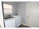 Laundry room with washer, dryer, and grey walls at 1897 Caryle Ln, The Villages, FL 32162