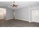Spacious living room showcasing neutral gray walls, stylish gray flooring, and a ceiling fan at 1897 Caryle Ln, The Villages, FL 32162
