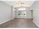Bright living room boasts vaulted ceilings, arched window, and modern gray-toned floors at 1897 Caryle Ln, The Villages, FL 32162