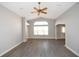 Bright living room with vaulted ceiling, wood-look floors, and a ceiling fan at 1897 Caryle Ln, The Villages, FL 32162