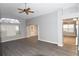 Open-concept living room with gray flooring, arched doorway, and ample natural light at 1897 Caryle Ln, The Villages, FL 32162