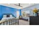 Charming bedroom with blue walls, brass bed frame, and window seat at 2197 Pearl Cider St, Orlando, FL 32824