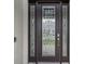 Elegant dark brown front door with glass inserts and sidelights at 2197 Pearl Cider St, Orlando, FL 32824