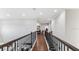 Upstairs hallway with dark wood floors and iron railings at 2197 Pearl Cider St, Orlando, FL 32824