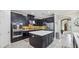 Spacious kitchen with island, stainless steel appliances, and dark cabinetry at 2197 Pearl Cider St, Orlando, FL 32824