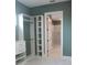 Walk-in closet leads to a modern bathroom featuring sleek marble floors and a luxurious walk-in shower at 2437 Bay Lake Loop, Groveland, FL 34736