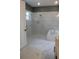 Modern bathroom featuring marble flooring, a walk-in shower, and a built-in tub for a luxurious feel at 2437 Bay Lake Loop, Groveland, FL 34736