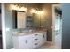Bright double vanity in a bathroom that leads to a large and roomy walk-in closet at 2437 Bay Lake Loop, Groveland, FL 34736