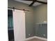 Bedroom with a barn door, ceiling fan, and small white shelf at 2437 Bay Lake Loop, Groveland, FL 34736