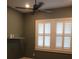 Bedroom with a modern ceiling fan and window with stylish white shutters at 2437 Bay Lake Loop, Groveland, FL 34736