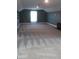 A spacious carpeted bedroom with plenty of natural light showcasing space for relaxation and personalization at 2437 Bay Lake Loop, Groveland, FL 34736
