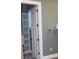 Open closet with white door revealing a built-in shelving unit, offering ample storage space at 2437 Bay Lake Loop, Groveland, FL 34736
