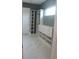 Large custom walk-in closet with drawers and shelves, complemented by elegant marble flooring at 2437 Bay Lake Loop, Groveland, FL 34736