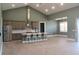 Inviting living room with stainless steel appliances, high ceiling, island with barstool seating at 2437 Bay Lake Loop, Groveland, FL 34736