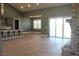 Open-concept living room featuring light wood floors, tall windows, and access to an island kitchen at 2437 Bay Lake Loop, Groveland, FL 34736