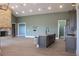Spacious kitchen, dining, and living area with views of stainless steel appliances and a brick fireplace at 2437 Bay Lake Loop, Groveland, FL 34736
