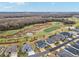 Aerial view of homes near a golf course and pond at 3606 Adamsville Ave, The Villages, FL 32163